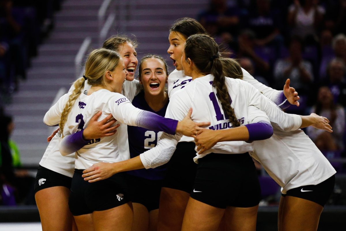 After a point, the volleyball team huddles in the middle of the court to celebrate the set during a fall 2022 game. Photo by Macey Franko.